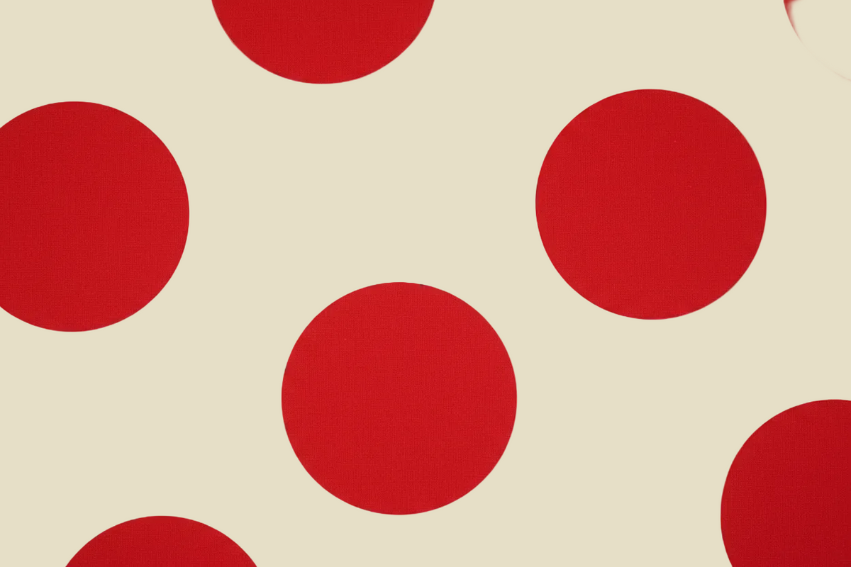 Red polka dots on a white background.
